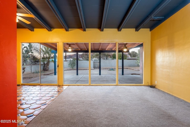 interior space featuring beam ceiling and carpet