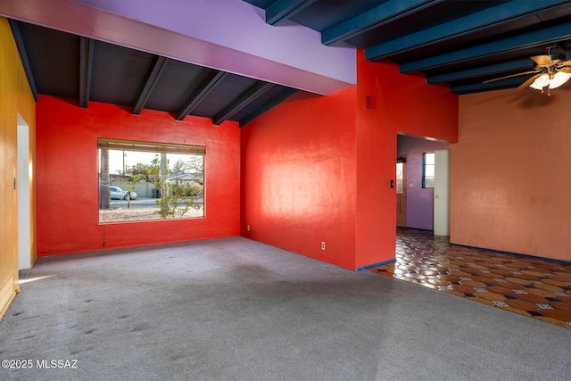 carpeted empty room with ceiling fan and lofted ceiling with beams