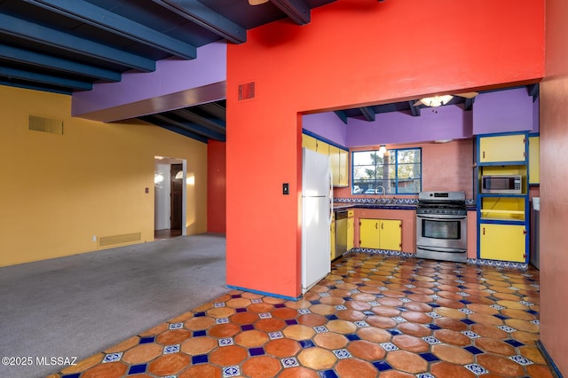 kitchen featuring stainless steel appliances, sink, light carpet, and beamed ceiling