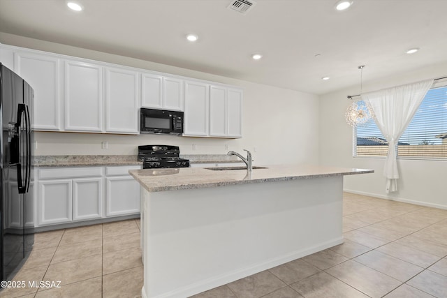 kitchen with hanging light fixtures, an island with sink, white cabinets, and black appliances