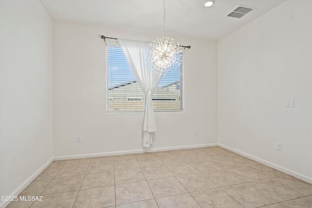 spare room featuring an inviting chandelier and light tile patterned floors