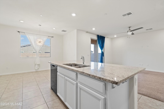 kitchen with ceiling fan with notable chandelier, white cabinetry, dishwasher, sink, and a kitchen island with sink