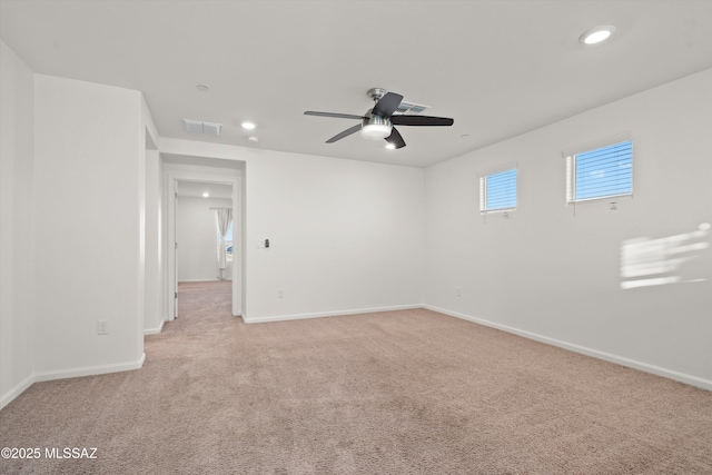 carpeted spare room with ceiling fan