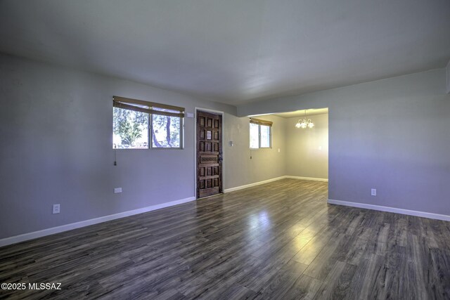 kitchen with white cabinets, appliances with stainless steel finishes, decorative light fixtures, sink, and a chandelier