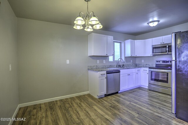 kitchen featuring light stone countertops, sink, white cabinetry, and appliances with stainless steel finishes