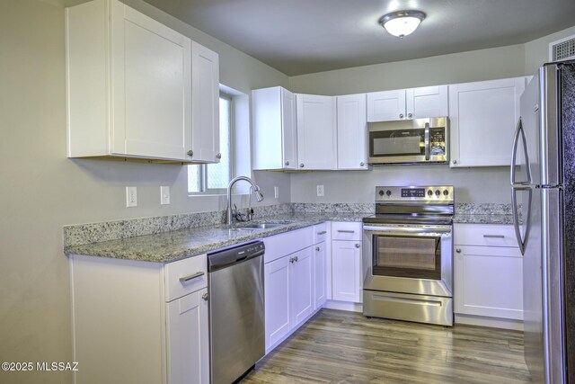 empty room with dark hardwood / wood-style flooring and stacked washer and clothes dryer