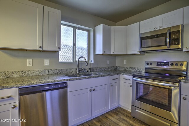 laundry room featuring dark colored carpet and stacked washer / drying machine