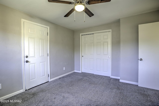 unfurnished bedroom with ceiling fan, a closet, and carpet floors