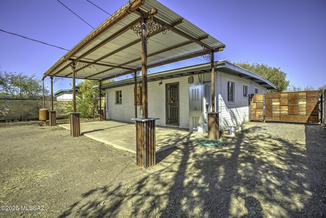 rear view of property featuring a patio area