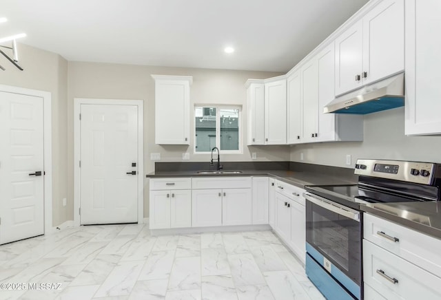 kitchen featuring stainless steel electric range oven, dark countertops, white cabinetry, a sink, and under cabinet range hood