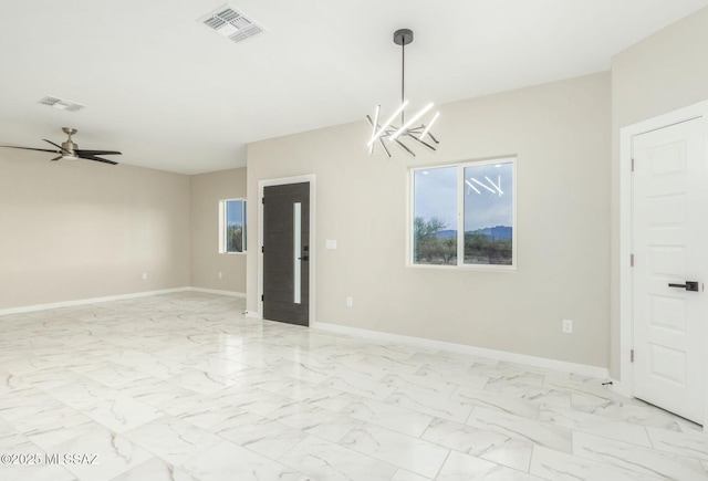 spare room with marble finish floor, visible vents, baseboards, and a healthy amount of sunlight