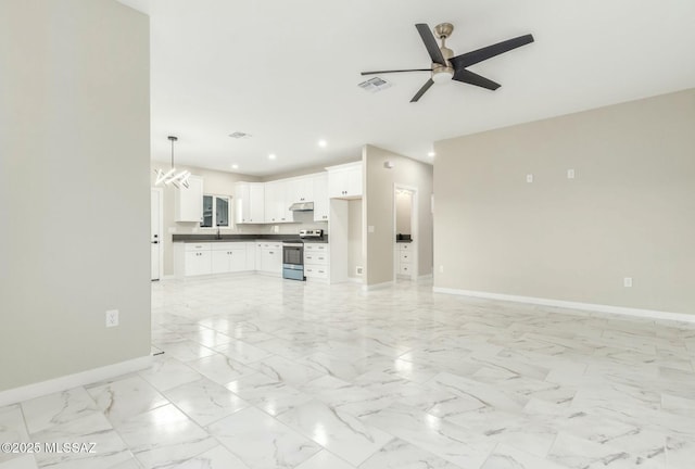 unfurnished living room with marble finish floor, recessed lighting, visible vents, baseboards, and ceiling fan with notable chandelier