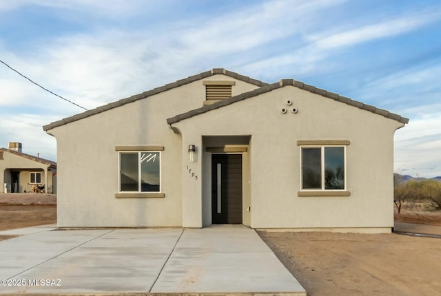 view of front facade with a patio area and stucco siding