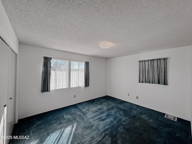 281 E Walker St, Benson, AZ 85602 - spare room with a textured ceiling and dark colored carpet