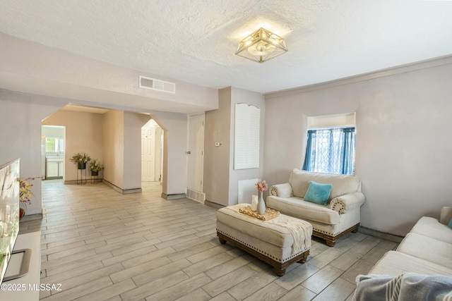 living room featuring a textured ceiling