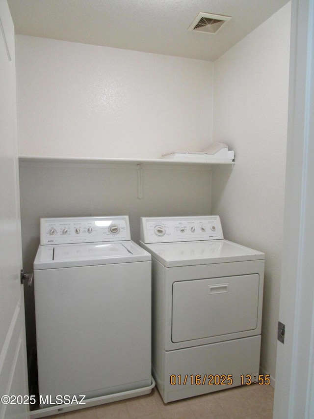 laundry area with washing machine and dryer