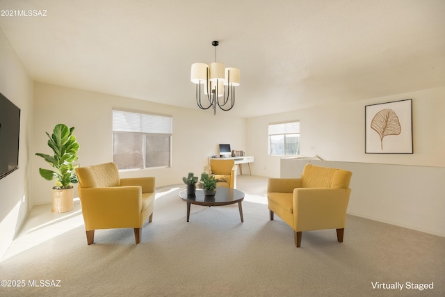 carpeted living room featuring a chandelier