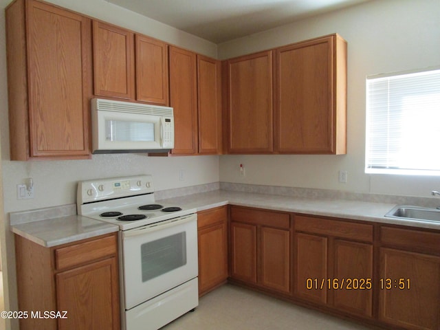 kitchen with sink and white appliances