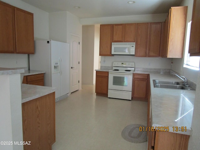 kitchen featuring sink and white appliances