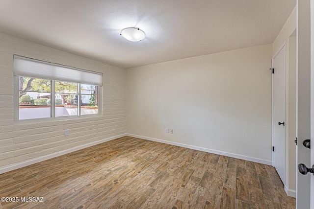 unfurnished room featuring hardwood / wood-style flooring