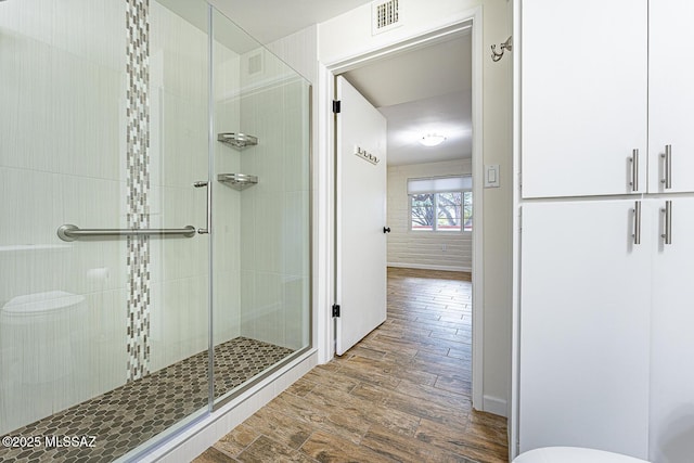 bathroom featuring hardwood / wood-style floors and walk in shower