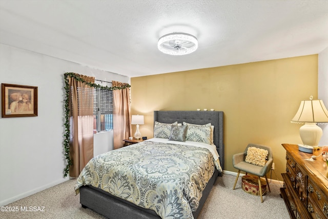 bedroom with light colored carpet and a textured ceiling