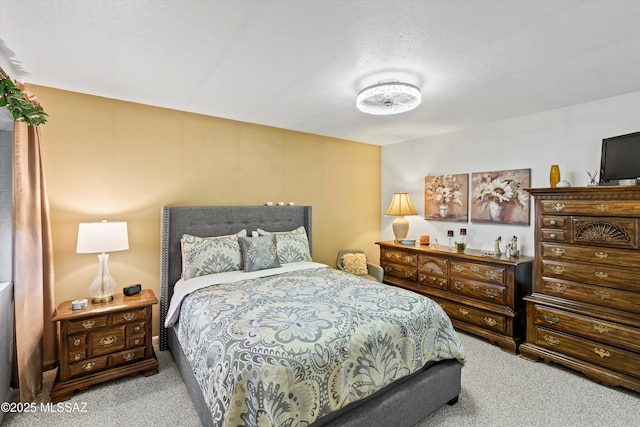 carpeted bedroom featuring a textured ceiling