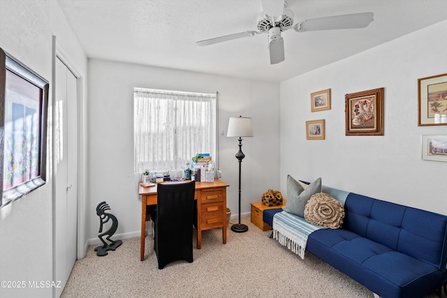 office space with ceiling fan, a textured ceiling, and light carpet