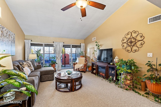 carpeted living room featuring ceiling fan and lofted ceiling