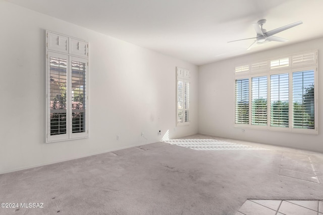 carpeted empty room with ceiling fan