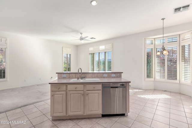 kitchen featuring hanging light fixtures, a kitchen island with sink, stainless steel dishwasher, sink, and ceiling fan with notable chandelier