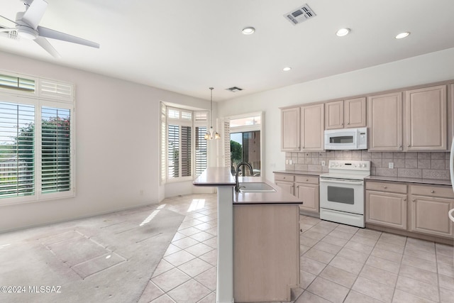 kitchen with sink, decorative light fixtures, backsplash, light tile patterned flooring, and white appliances