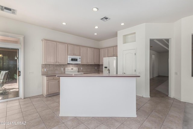 kitchen with white appliances, light tile patterned floors, a center island with sink, and tasteful backsplash