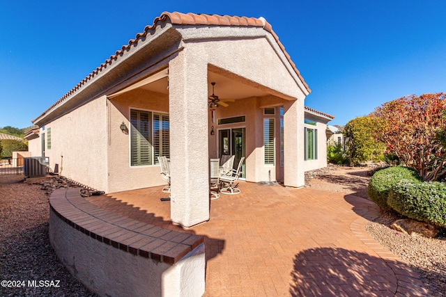 back of property with ceiling fan, a patio, and central air condition unit