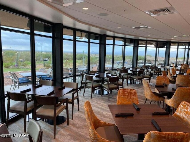 dining space featuring floor to ceiling windows