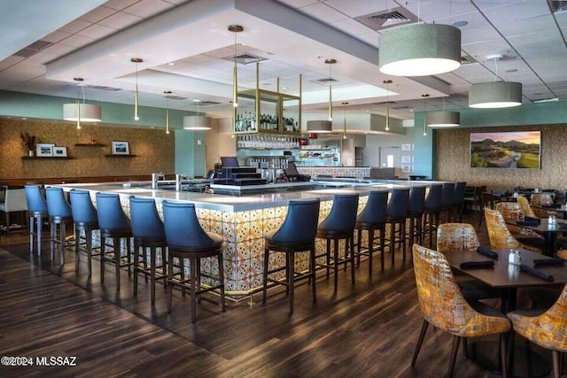 bar with pendant lighting and dark hardwood / wood-style floors