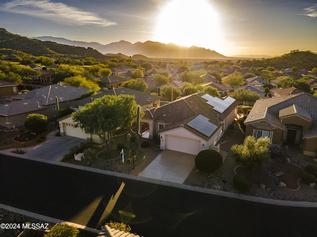 aerial view at dusk featuring a mountain view