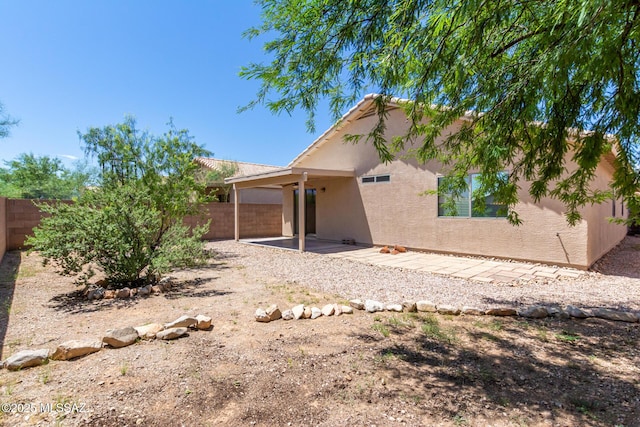 back of house with a patio