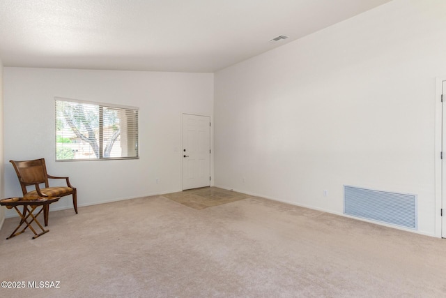 living area with light colored carpet and lofted ceiling