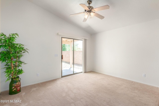 carpeted spare room featuring ceiling fan and lofted ceiling