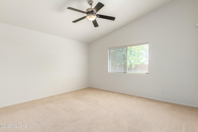 carpeted empty room featuring ceiling fan and vaulted ceiling