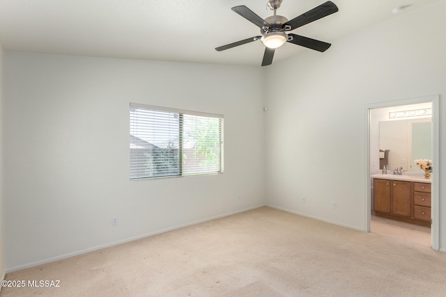 unfurnished bedroom with ceiling fan, light carpet, vaulted ceiling, and connected bathroom