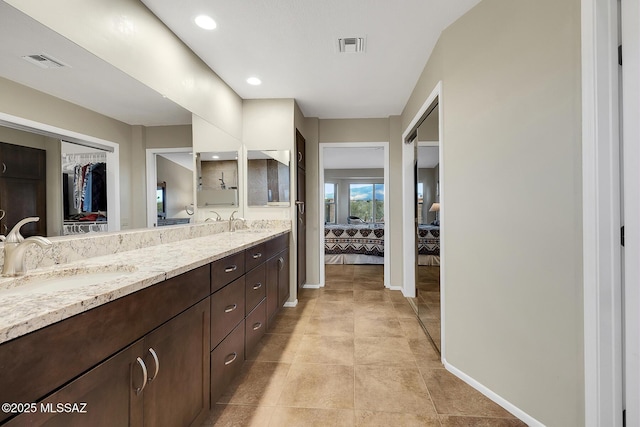 bathroom with tile patterned floors and vanity