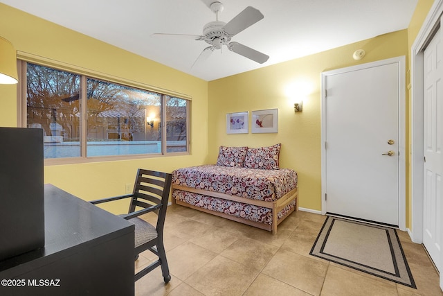 bedroom featuring ceiling fan, light tile patterned floors, and a closet