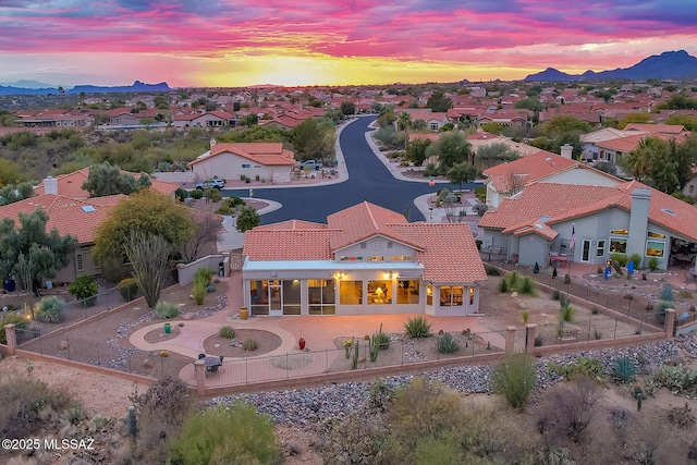 aerial view at dusk featuring a mountain view