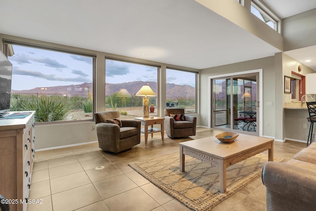 living room with plenty of natural light, light tile patterned flooring, and a mountain view