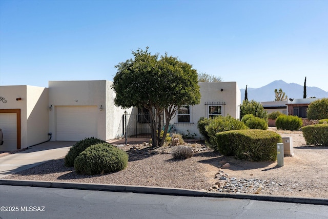 pueblo revival-style home featuring a garage and a mountain view