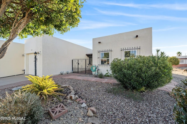 rear view of property featuring a garage