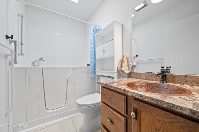 bathroom featuring tile patterned floors, toilet, and vanity