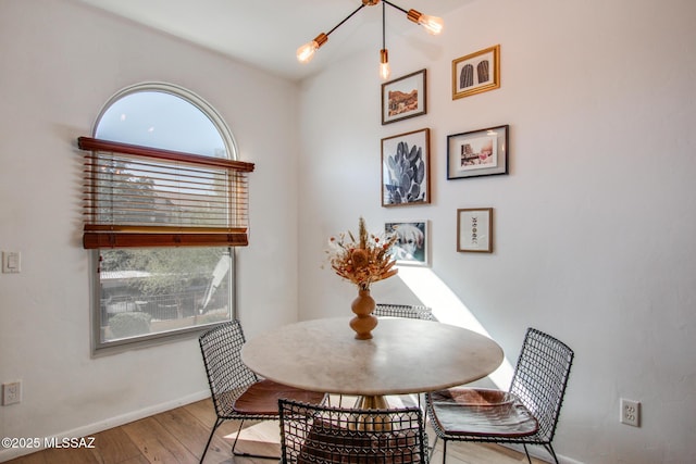 dining area featuring light hardwood / wood-style floors and a notable chandelier